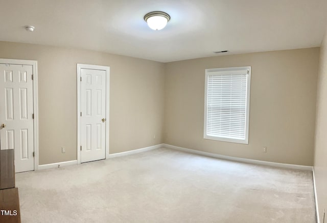 unfurnished room with carpet flooring, baseboards, and a smoke detector