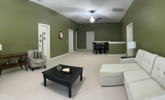 living room featuring a ceiling fan, carpet, and baseboards