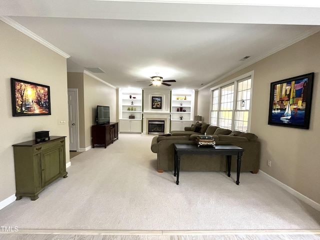 living room featuring ornamental molding, ceiling fan, light colored carpet, baseboards, and a fireplace with raised hearth
