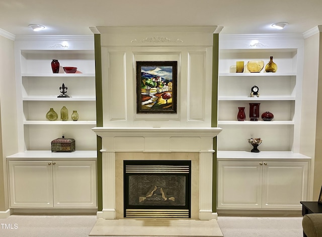 detailed view of a fireplace, ornamental molding, and built in features