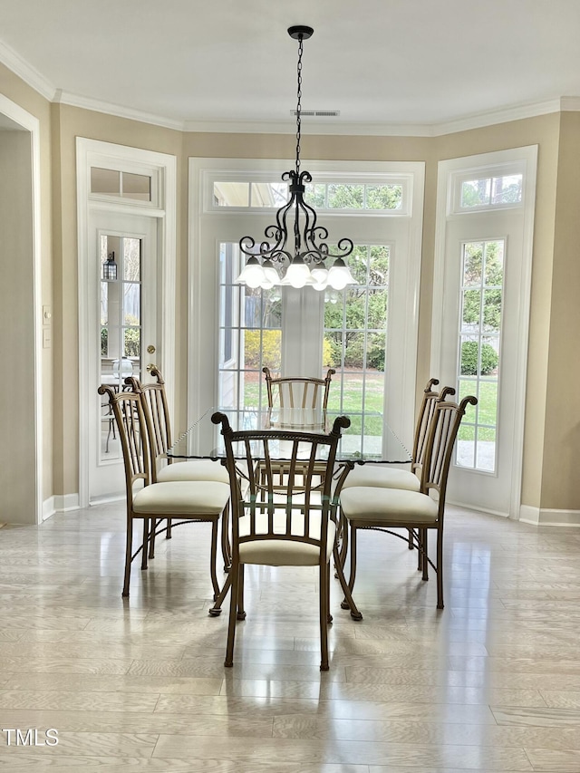 dining area featuring plenty of natural light, a chandelier, baseboards, crown molding, and light wood-style floors