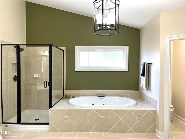 bathroom with a stall shower, a garden tub, vaulted ceiling, toilet, and tile patterned floors