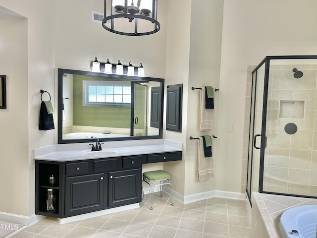 bathroom with a towering ceiling, a shower stall, baseboards, tile patterned flooring, and a garden tub