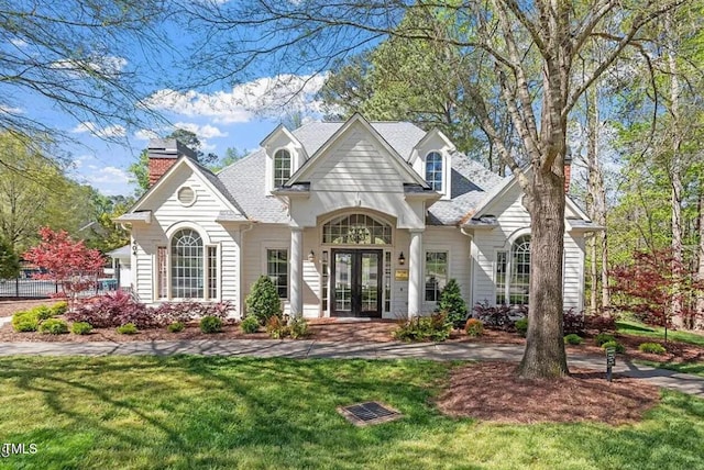 view of front of house featuring french doors and a chimney
