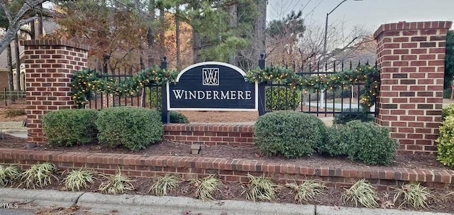 community sign featuring fence