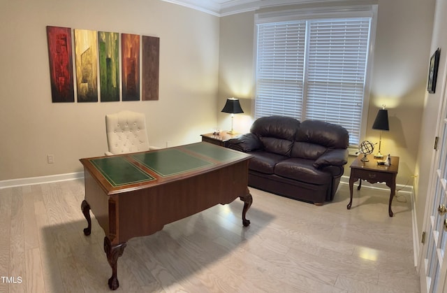game room with light wood-style flooring, ornamental molding, and baseboards