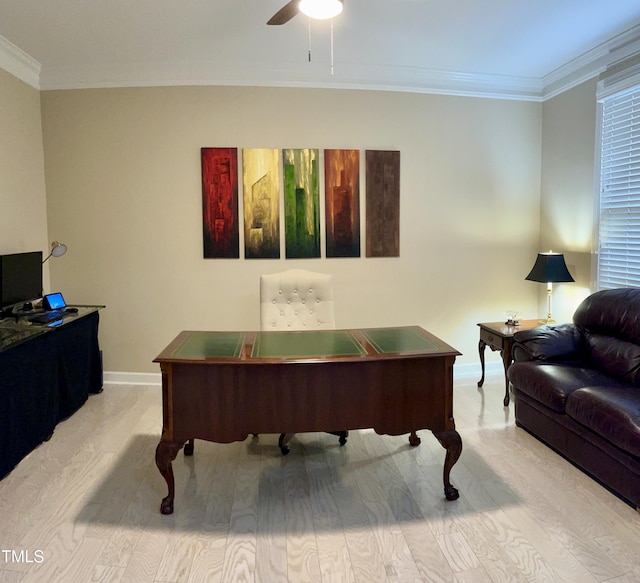 home office with baseboards, ceiling fan, ornamental molding, and light wood-type flooring