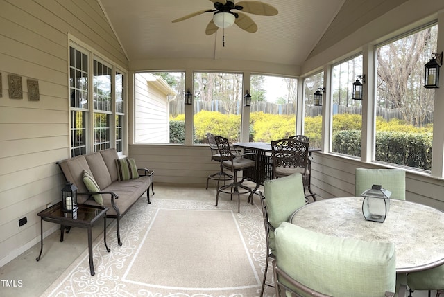 sunroom featuring outdoor dining space, lofted ceiling, a ceiling fan, and an outdoor hangout area