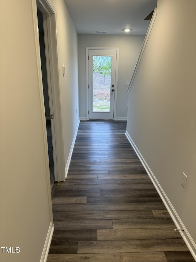entryway featuring dark wood-style flooring and baseboards
