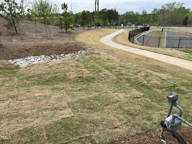 view of home's community featuring fence