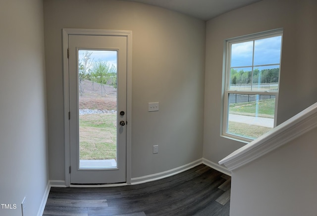 doorway to outside featuring dark wood finished floors and baseboards