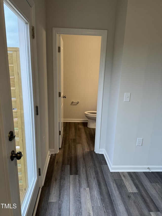 bathroom with wood finished floors, toilet, and baseboards