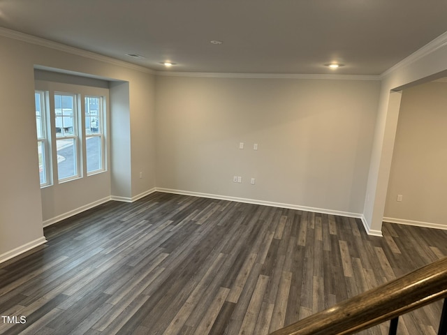 empty room featuring dark wood-style floors, crown molding, baseboards, and recessed lighting