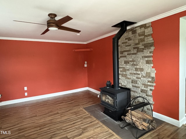 704 S Mineral Springs Rd, Durham, NC 27703 - unfurnished living room featuring a wood stove, ceiling fan, baseboards, wood finished floors, and crown molding