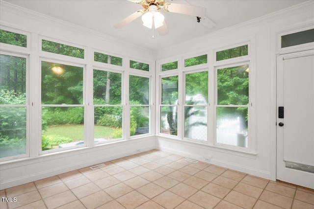 unfurnished sunroom with tile patterned flooring, healthy amount of natural light, and ornamental molding
