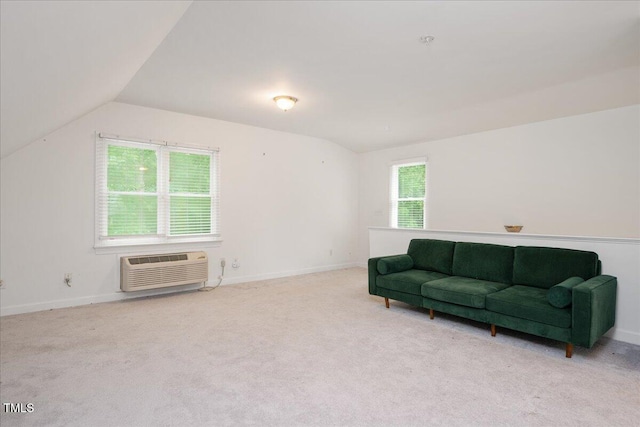 sitting room with a wall mounted air conditioner, carpet floors, vaulted ceiling, and baseboards