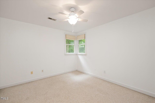 carpeted empty room featuring ceiling fan and baseboards