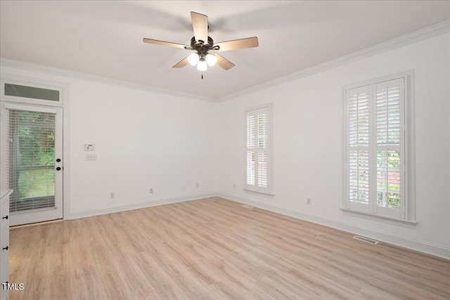 spare room with light wood-style floors, crown molding, healthy amount of natural light, and ceiling fan