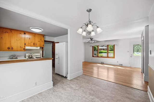 330 Wilmot Dr, Raleigh, NC 27606 - kitchen with white fridge with ice dispenser, range, a chandelier, under cabinet range hood, and open floor plan