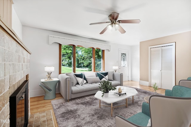 330 Wilmot Dr, Raleigh, NC 27606 - living area featuring a ceiling fan, a fireplace with flush hearth, light wood-type flooring, and baseboards