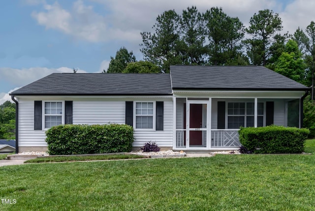view of front of property with a front lawn, covered porch, and a shingled roof