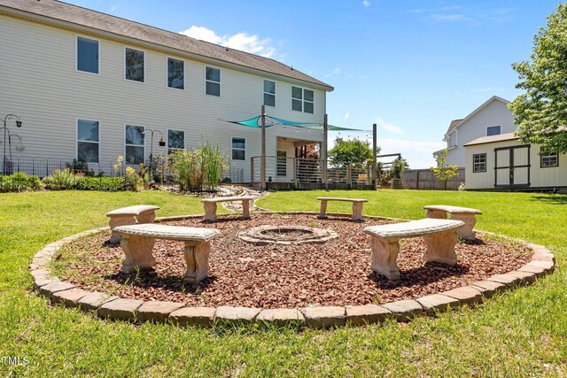 870 Kentucky Derby Ln, Lillington, NC 27546 - rear view of property with a storage unit, an outdoor structure, and an outdoor fire pit