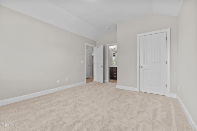 870 Kentucky Derby Ln, Lillington, NC 27546 - unfurnished bedroom with vaulted ceiling, light carpet, baseboards, and connected bathroom