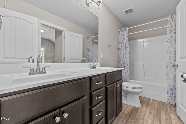 870 Kentucky Derby Ln, Lillington, NC 27546 - bathroom with wood finished floors, shower / bath combination with curtain, toilet, and double vanity