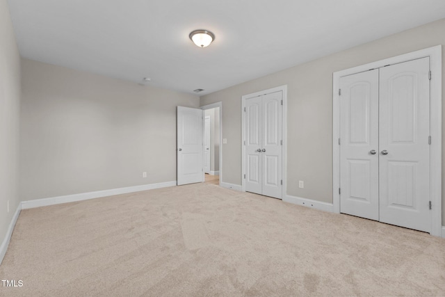 870 Kentucky Derby Ln, Lillington, NC 27546 - unfurnished bedroom featuring two closets, baseboards, and carpet floors