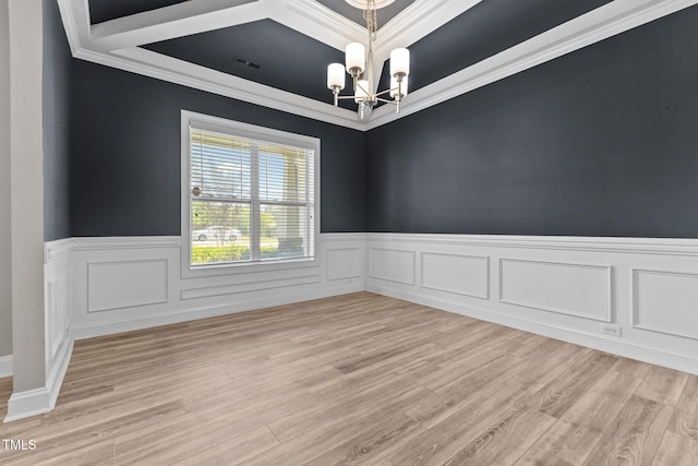 870 Kentucky Derby Ln, Lillington, NC 27546 - empty room featuring a chandelier, a wainscoted wall, light wood finished floors, and ornamental molding