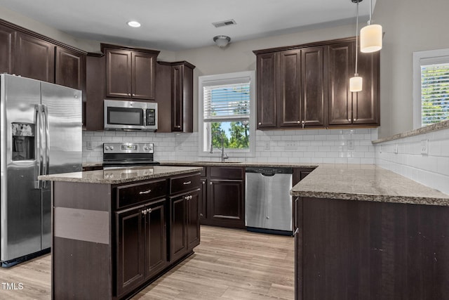 870 Kentucky Derby Ln, Lillington, NC 27546 - kitchen with appliances with stainless steel finishes, a sink, light stone countertops, light wood-type flooring, and recessed lighting