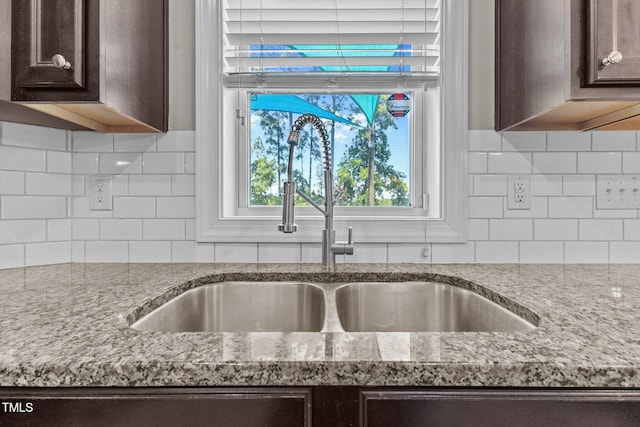 870 Kentucky Derby Ln, Lillington, NC 27546 - kitchen view of a sink, dark brown cabinetry, and tasteful backsplash
