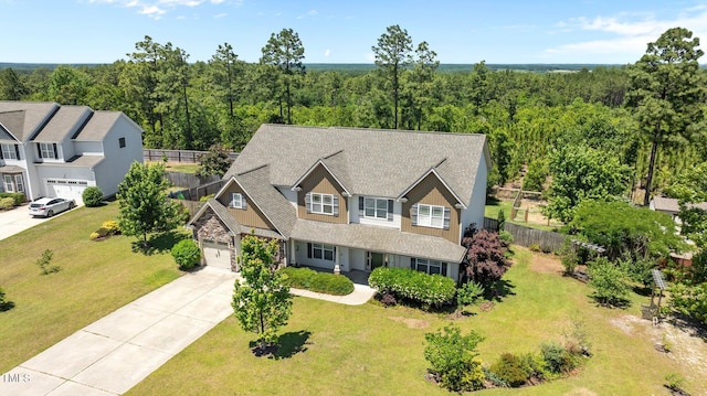 870 Kentucky Derby Ln, Lillington, NC 27546 - view of front of home featuring concrete driveway, an attached garage, and a wooded view