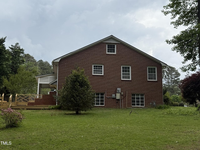 420 Rodwell St, Warrenton, NC 27589 - view of side of home featuring a lawn, brick siding, and a deck