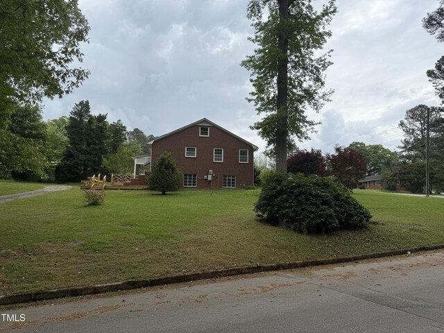 420 Rodwell St, Warrenton, NC 27589 - view of home's exterior with a lawn, brick siding, and a deck