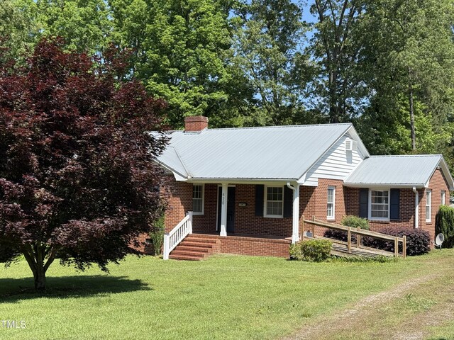 420 Rodwell St, Warrenton, NC 27589 - ranch-style house featuring a front lawn, brick siding, metal roof, and a chimney