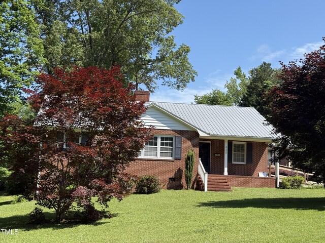 420 Rodwell St, Warrenton, NC 27589 - ranch-style home with a front lawn, a chimney, brick siding, metal roof, and crawl space