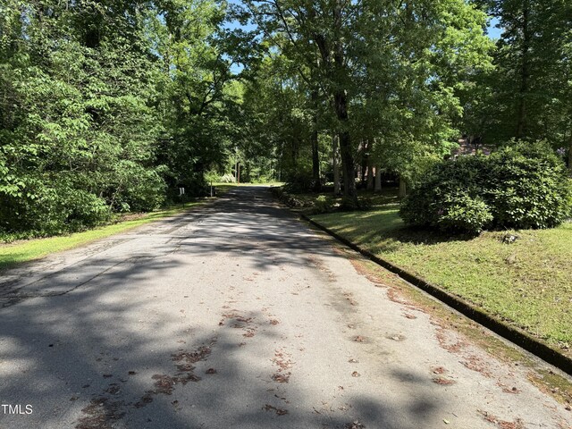 420 Rodwell St, Warrenton, NC 27589 - view of asphalt street featuring curbs and a view of trees