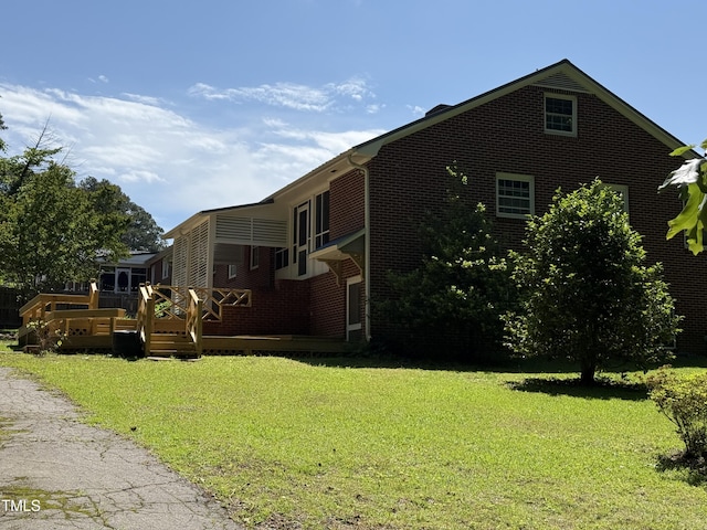 420 Rodwell St, Warrenton, NC 27589 - view of side of property with brick siding, a yard, and a deck
