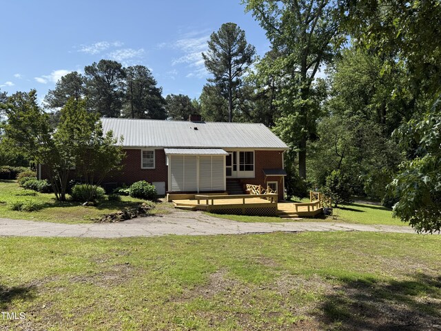 420 Rodwell St, Warrenton, NC 27589 - ranch-style house with a wooden deck, a front yard, and metal roof
