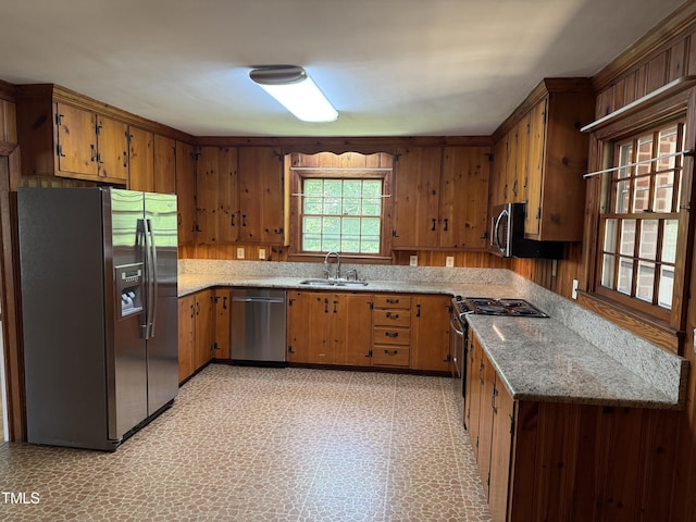 420 Rodwell St, Warrenton, NC 27589 - kitchen featuring stainless steel appliances, a sink, brown cabinets, light stone counters, and light floors
