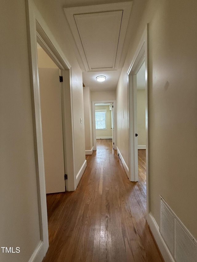 420 Rodwell St, Warrenton, NC 27589 - corridor featuring attic access, wood finished floors, and baseboards