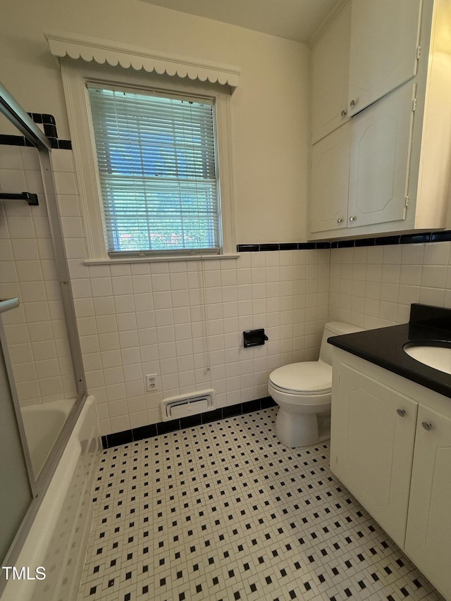420 Rodwell St, Warrenton, NC 27589 - full bathroom featuring tile walls, toilet, tile patterned floors, vanity, and wainscoting