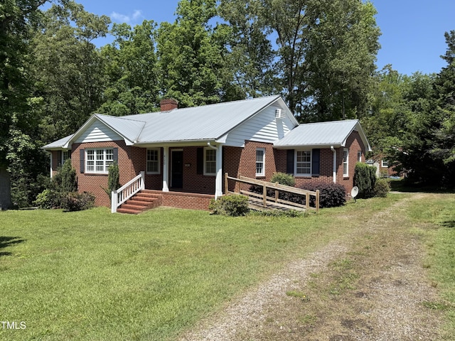 420 Rodwell St, Warrenton, NC 27589 - ranch-style home featuring brick siding, a front lawn, covered porch, a chimney, and dirt driveway