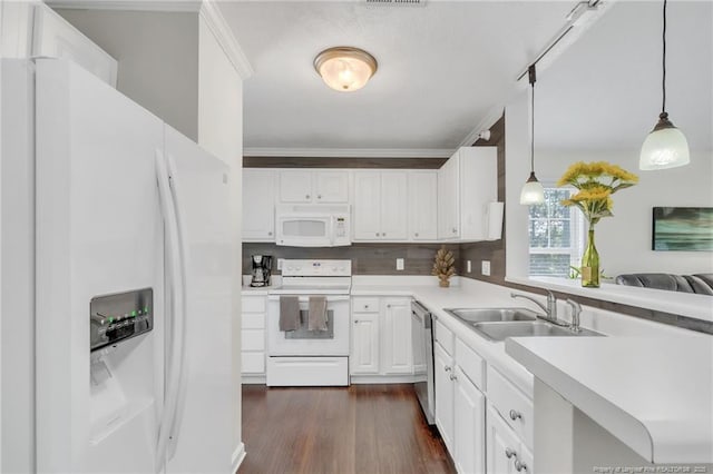 kitchen with white appliances, a sink, dark wood-style floors, light countertops, and white cabinets
