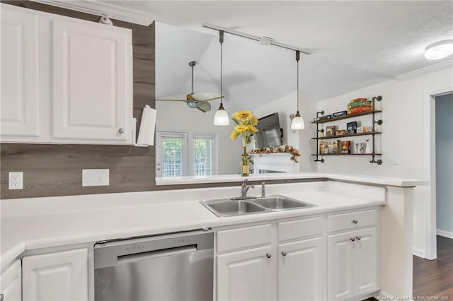 kitchen with dishwasher, a sink, white cabinetry, light countertops, and lofted ceiling