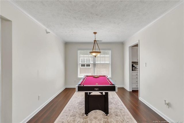 playroom featuring pool table, dark wood-style flooring, a textured ceiling, baseboards, and crown molding