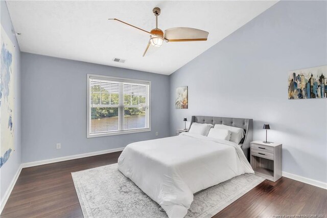bedroom featuring wood finished floors, baseboards, a ceiling fan, and vaulted ceiling