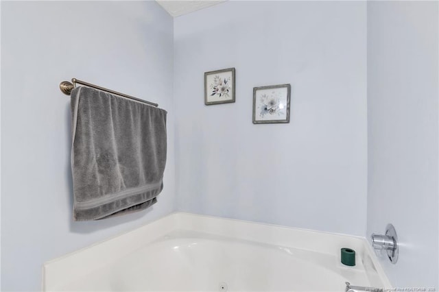 bathroom with a tub with jets