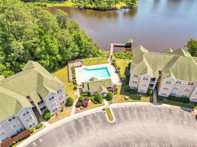 bird's eye view of a nearby body of water and a pool
